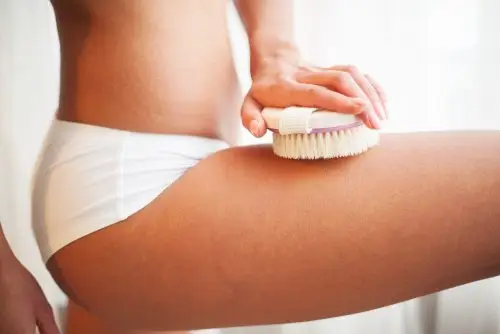 Women's leg with dry body brushing