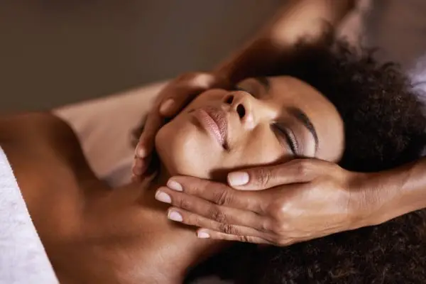 Calm spa client receiving facial massage for relaxation